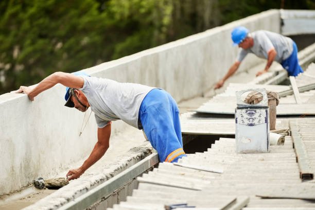 Shot of two construction workers building a rooftop